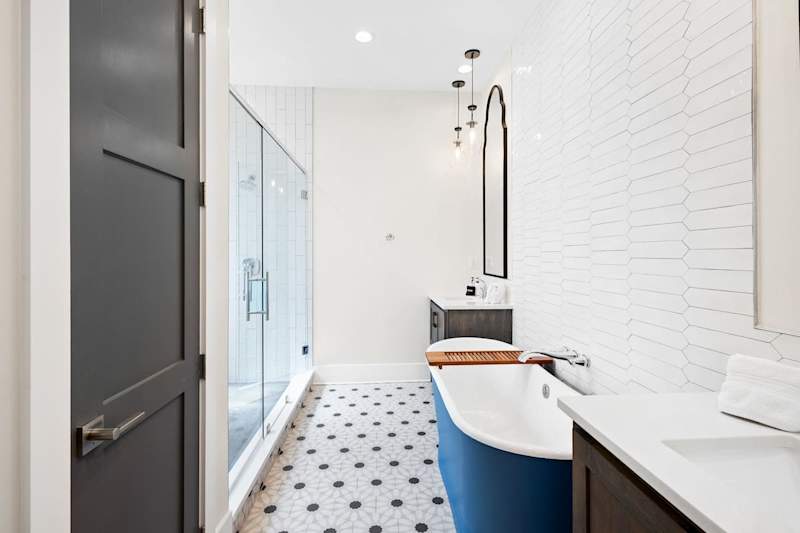 Bathroom includes a dual head walk-in shower and large soaking tub.
