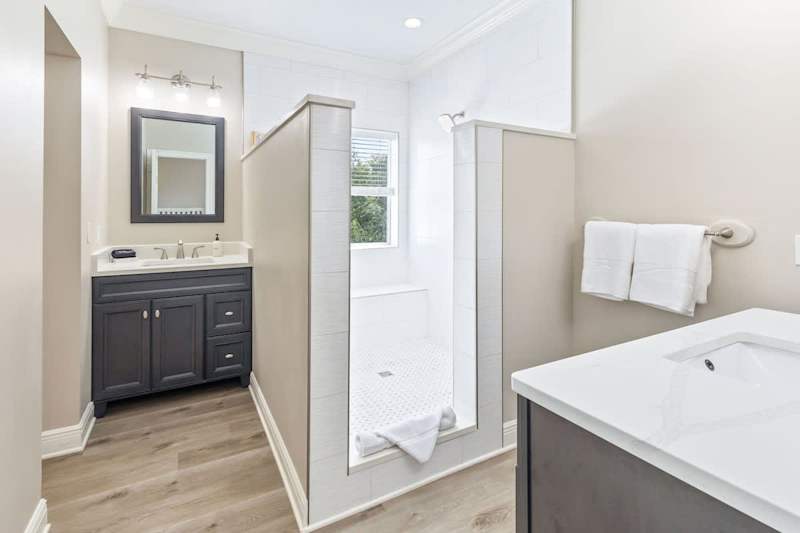 Bathroom features 2 vanities and walk-in shower.