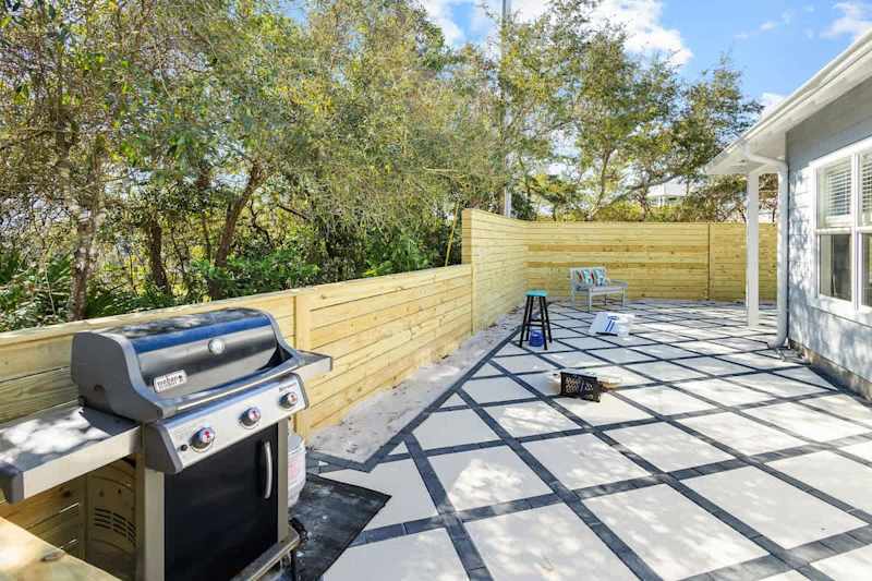 Patio features a gas grill and yard games.