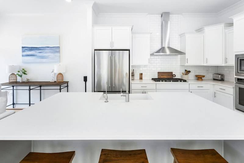 Large kitchen island includes seating for three.