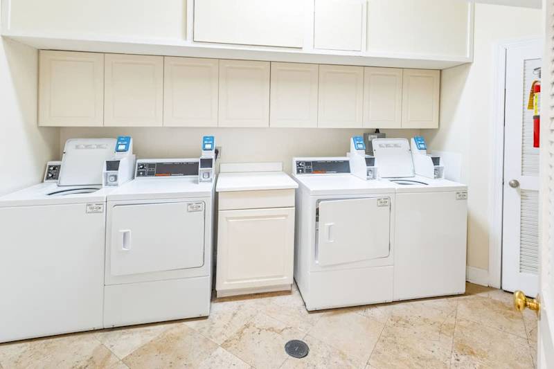 Credit card operated washer/dryer available steps outside of condo door.