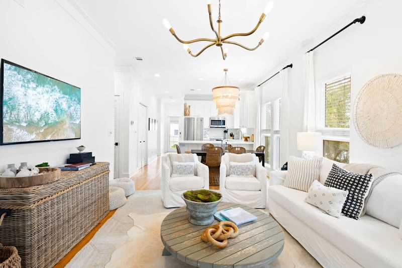 Living room features plenty of seating for all and a smart tv!