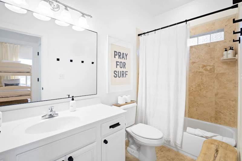 Guest bathroom features a shower/tub combo.