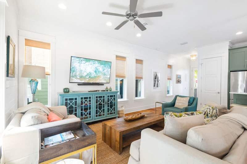 Living room space feature coastal touches with a smart tv.