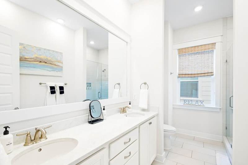 Bathroom features double vanities and walk-in shower.