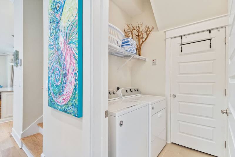 Main floor laundry room features a full washer and dryer.