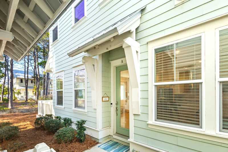 Entrance to home is to the left of the driveway.