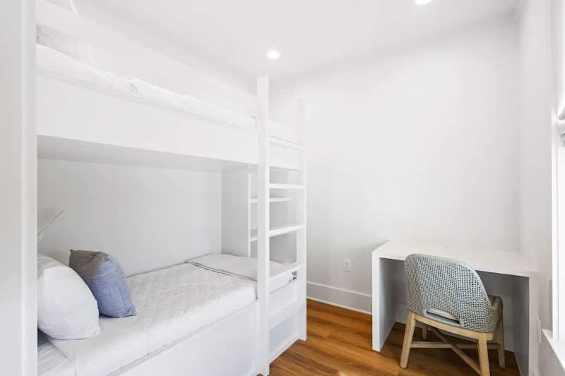 Bedroom #1 features a twin over twin bunk and workspace.