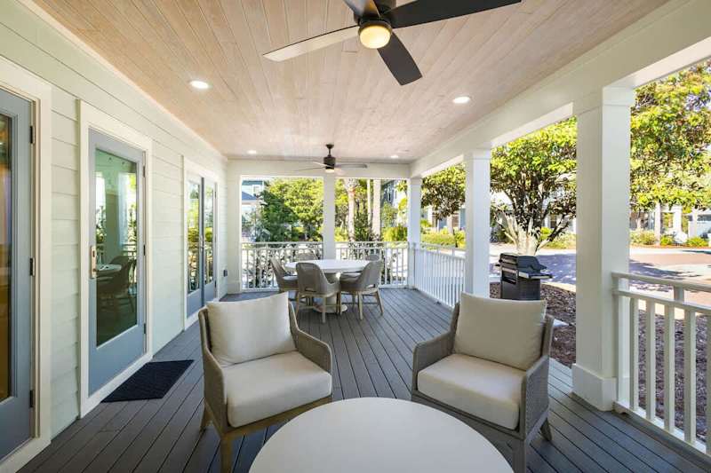Back patio includes lots of seating, a smart tv.