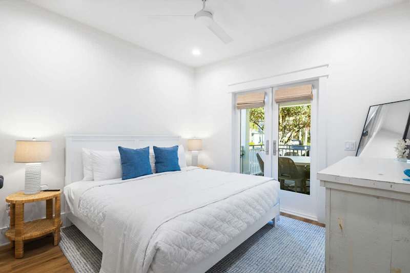 Bedroom #3 features a king bed, ensuite, smart tv and walkout to back patio.