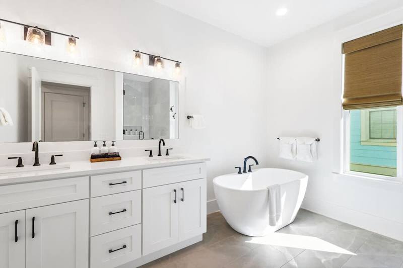 Bathroom features dual vanities, soaker tub and walk-in shower.