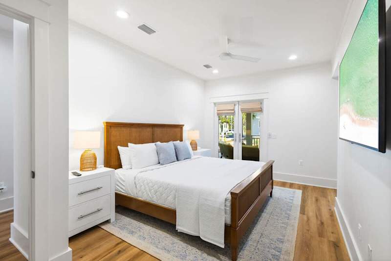 Bedroom #4 features a king bed, ensuite, smart tv and walkout to back patio.
