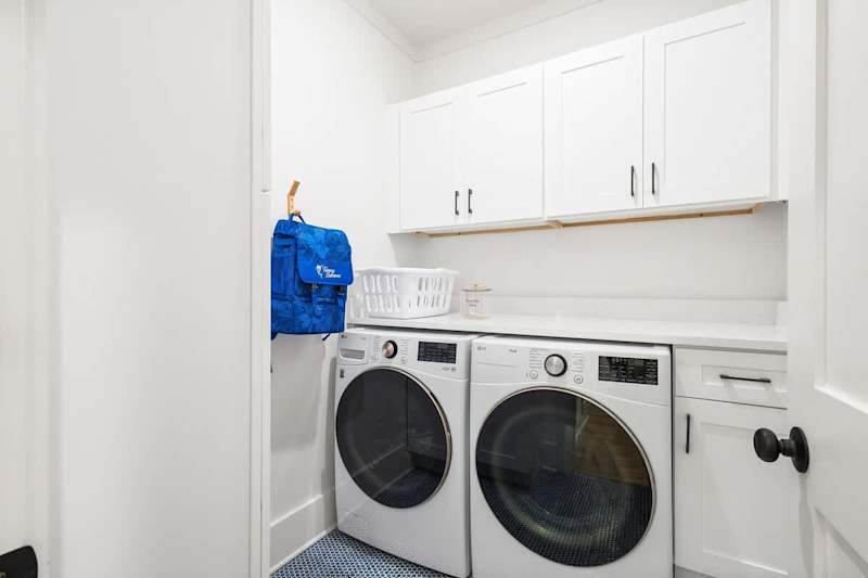 Laundry room features a full washer and dryer.