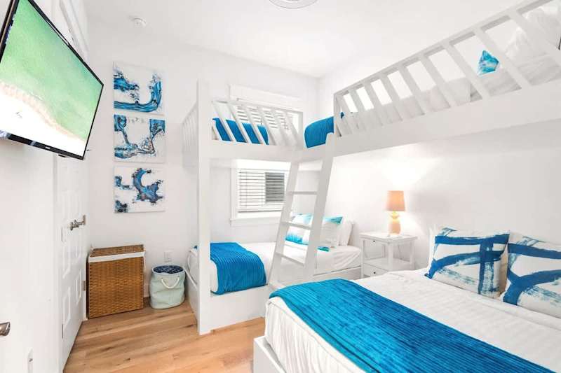 Bedroom #2 features bunks and a smart tv. (1) twin over twin, (1) twin over full
