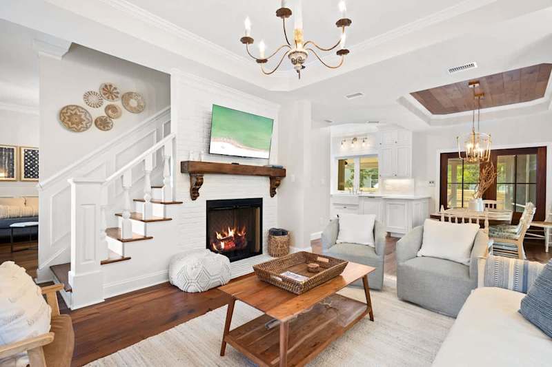 Living room features plenty of you seating for everyone, a smart tv and gas fireplace.