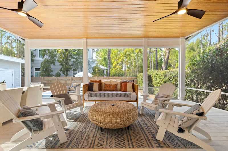 Large screened in back porch features tons of seating.