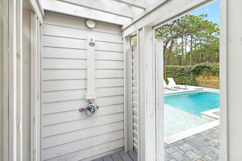 Pool features an outdoor shower.