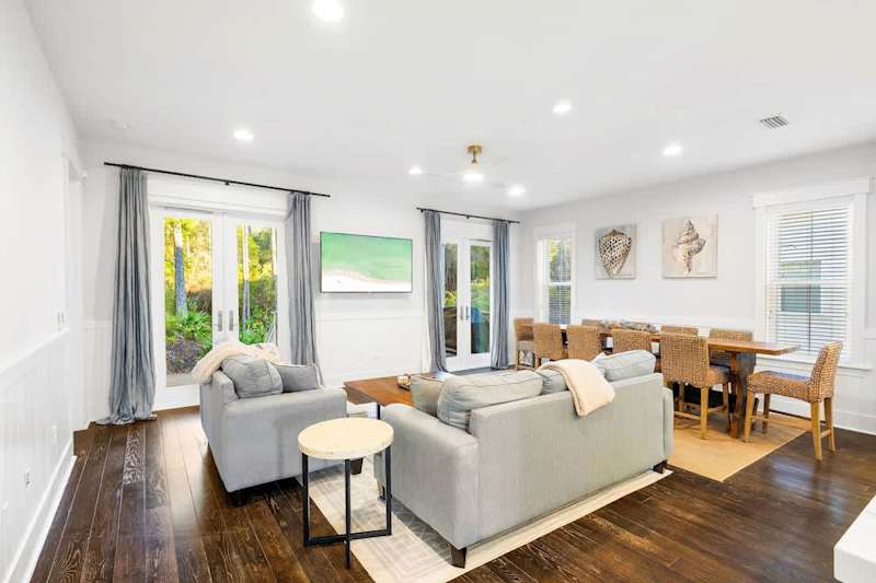 Living room features plenty of seating for all and a smart tv.