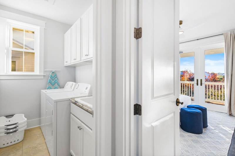 Second floor laundry room features a full wash and dryer.