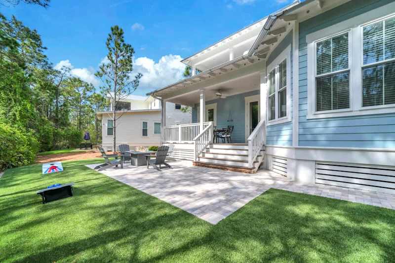 Backyard includes fire pit seating area and space for games.
