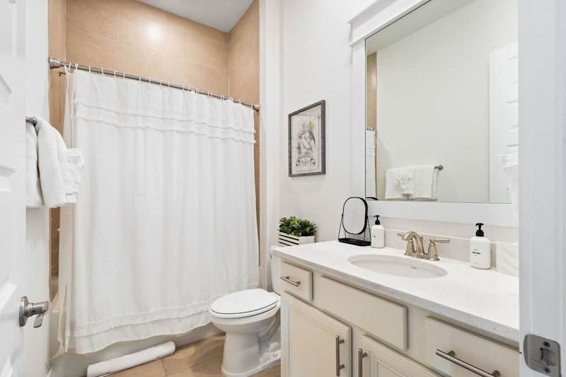 Full guest bathroom features a shower/tub combo.