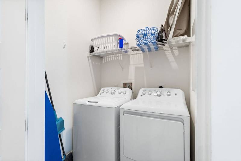 Laundry room features a full washer and dryer.