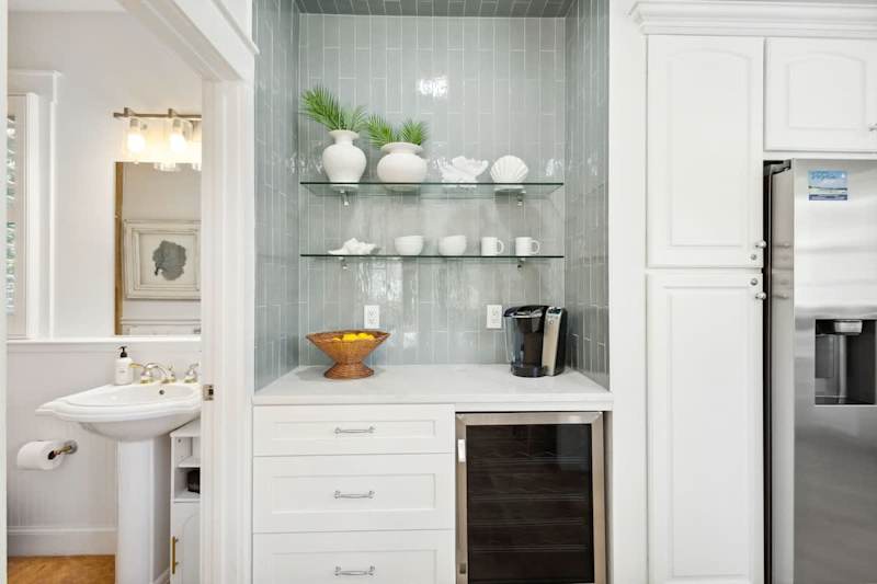Kitchen features a coffee bar with a beverage cooler.