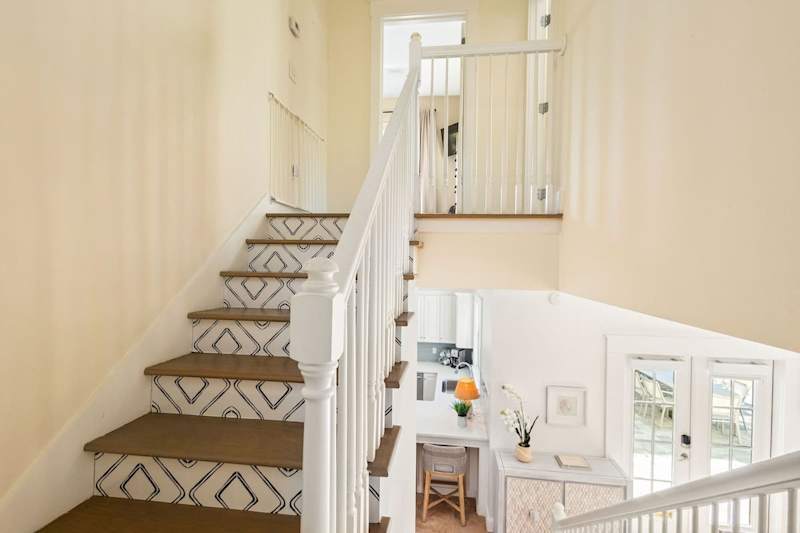 Stairs lead the the second floor which features the homes two bedrooms.