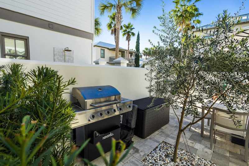 Patio is equipped with a gas grill and all your beach essentials are tucked in the outdoor storage box.
