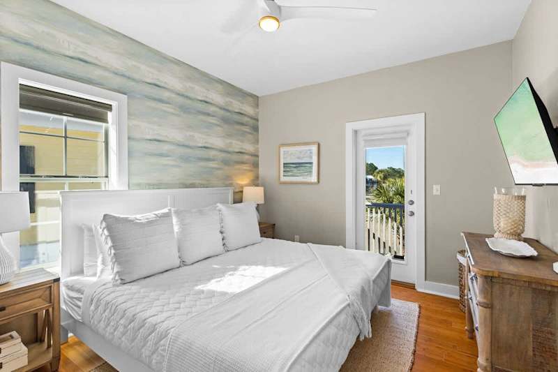 Primary bedroom features a smart tv, ensuite and walkout to balcony.