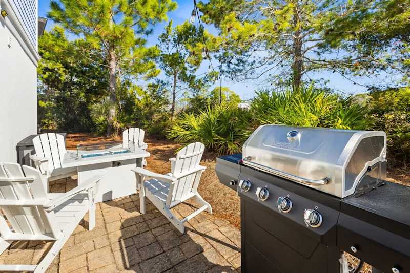 Patio off dining room features a fire pit and gar grill.