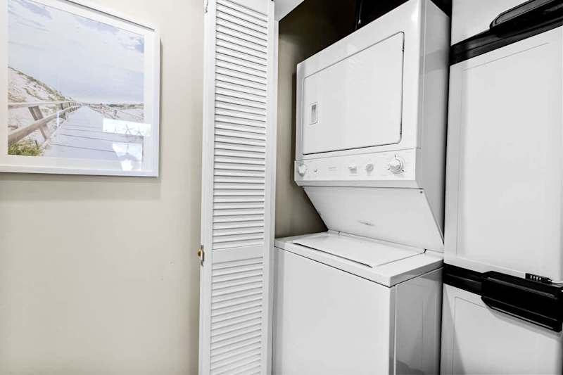 Full washer and dryer located in first floor half bathroom.