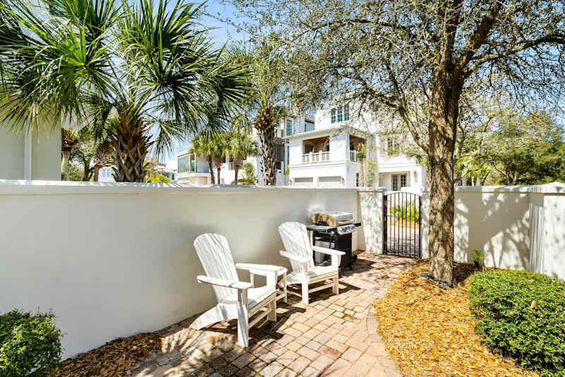 Outdoor grill and seating area on front patio.