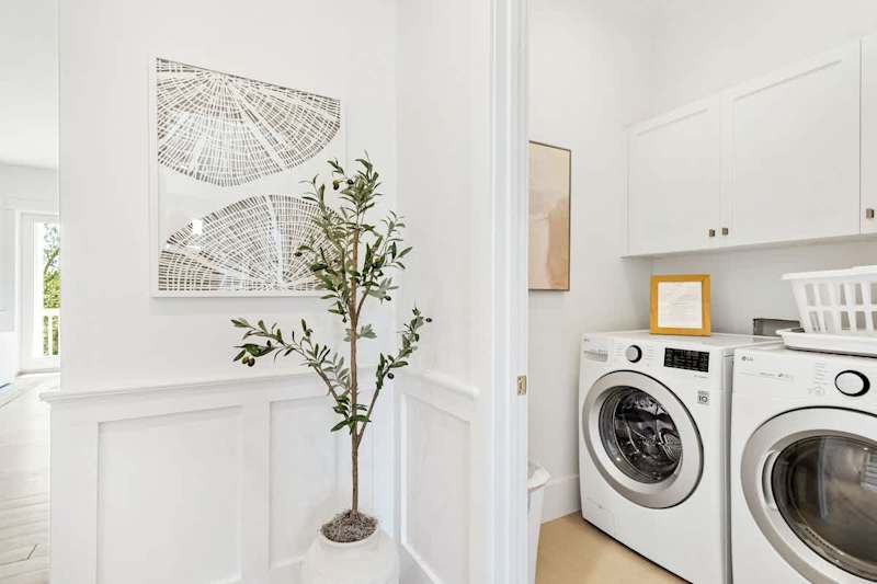 Laundry room featuring a full washer and dryer on the second floor.