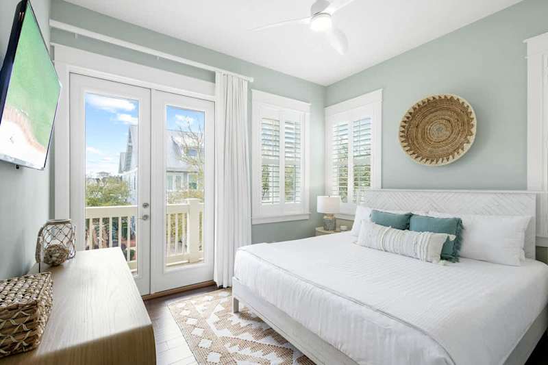 Guest bedroom features a king bed, smart tv and walk out to balcony.