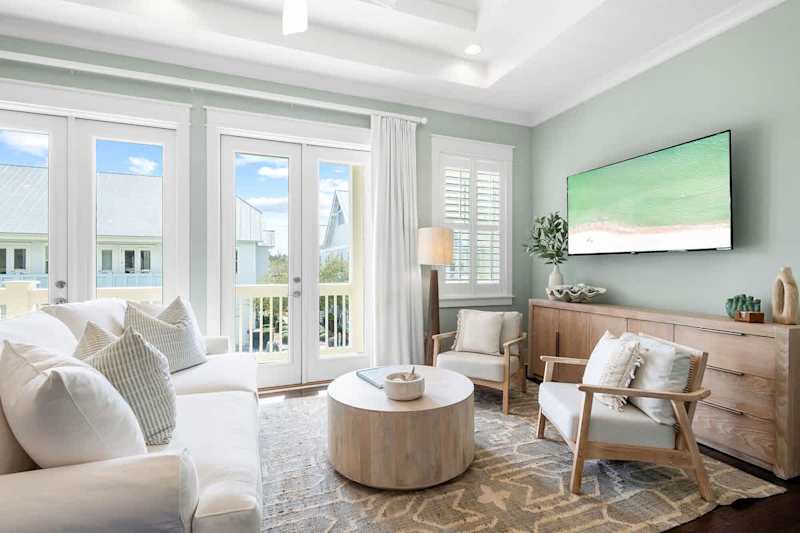 Living room features a smart tv and plenty of seating.