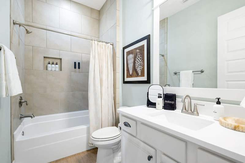 Guest bathroom features a shower/tub combo.