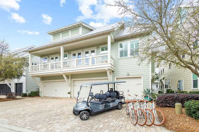 Home features a 6 seater golf cart, 4 adult bikes and 1 driveway parking space in front of the single garage door.