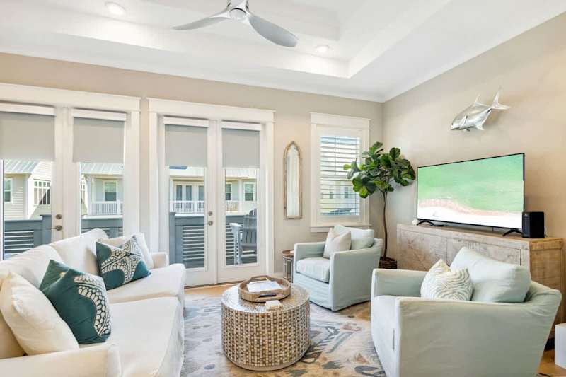 Living room features a smart tv and plenty of seating.