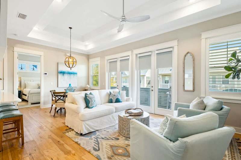 Living room features a smart tv and plenty of seating.