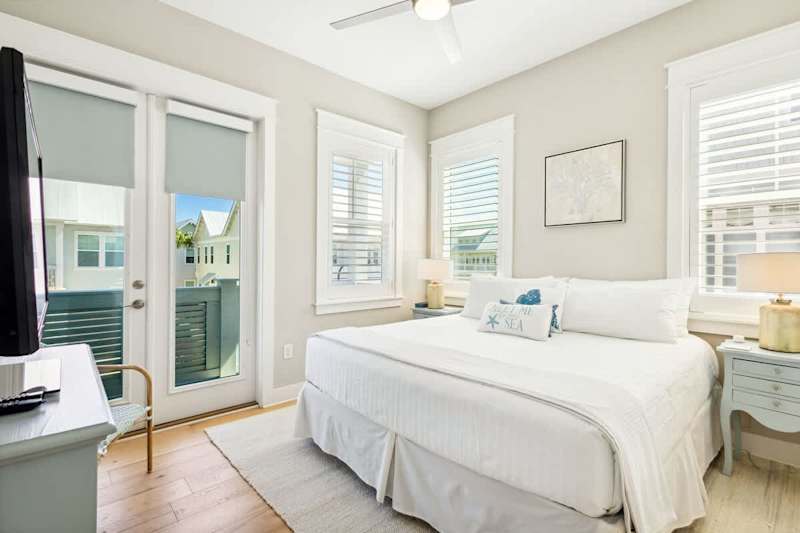 Guest bedroom features a king bed, smart tv and walk out to balcony.