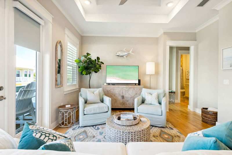 Living room features a smart tv and plenty of seating.