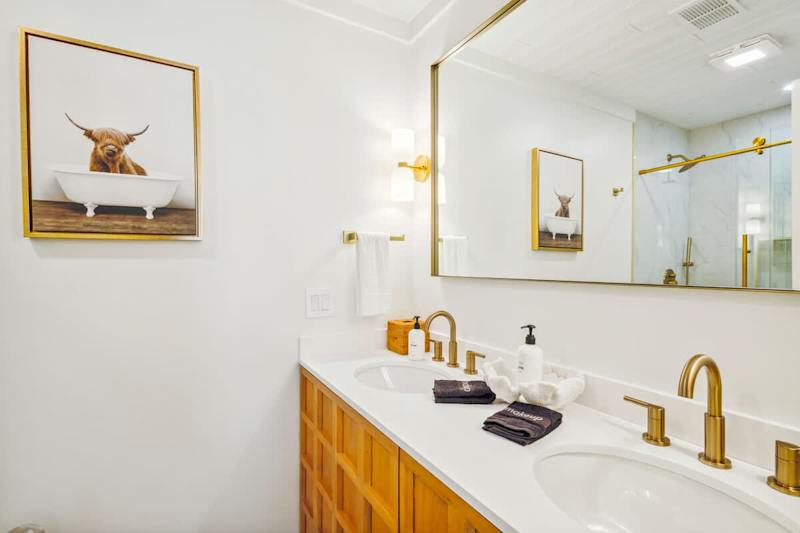 Bathroom features dual vanities and a large walk-in shower.