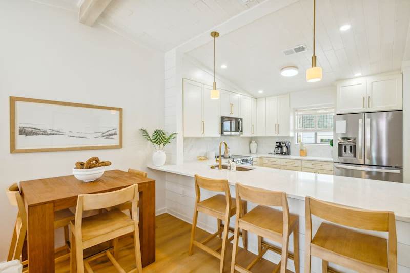 Kitchen island features seating for 3 with additional seating for 3 at the dining table.