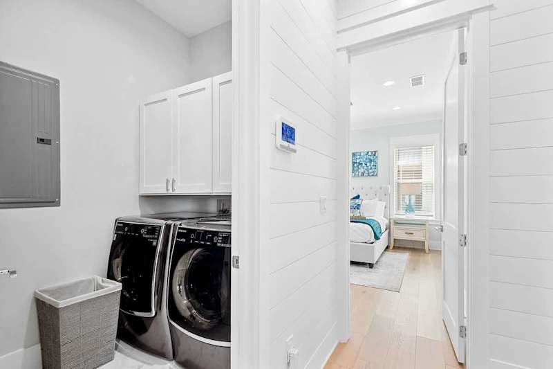 First floor laundry room features a large capacity washer and dryer.