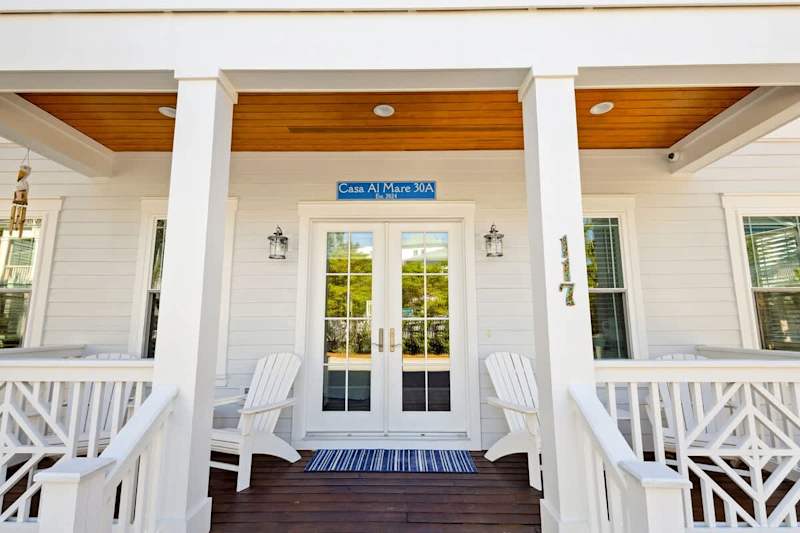Front porch includes seating and is the perfect spot to watch the unforgettable colors of a 30a sunset.