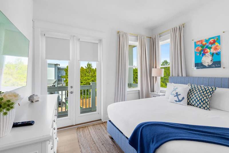 Guest bedroom features a king bed, smart tv and walk out to balcony.