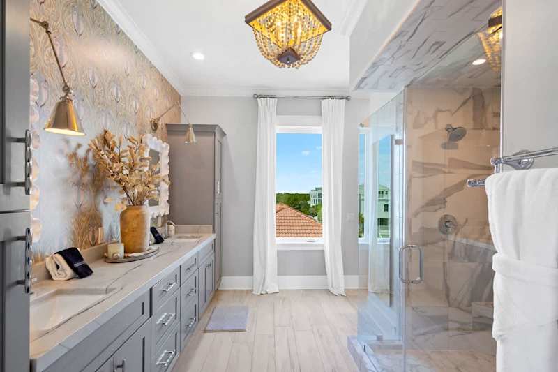 Bathroom features dual vanities and a large walk-in shower.