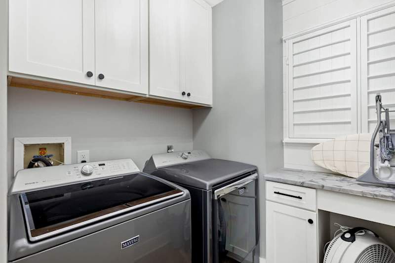 Second floor laundry features a full washer and dryer.