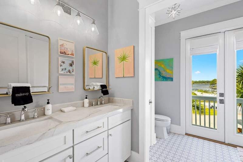 Bathroom features dual vanities, a shower tub/combo and a view!